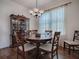 Elegant dining room featuring a wood table, chandelier, and beautiful sheer curtains at 320 Bentwood Dr, Leesburg, FL 34748