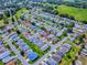 Overhead view of a charming neighborhood featuring neatly arranged homes with lush green lawns and mature trees at 32708 Westwood Loop, Leesburg, FL 34748