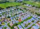 High-angle view of a quaint neighborhood featuring well-maintained homes, mature trees, and green spaces at 32708 Westwood Loop, Leesburg, FL 34748
