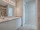The bathroom features a dual-sink vanity and a tile walk-in shower at 32708 Westwood Loop, Leesburg, FL 34748