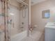 This bathroom features a shower-tub combo with light tile flooring at 32708 Westwood Loop, Leesburg, FL 34748