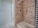 The tiled walk-in shower with grab bars and a shower curtain at 32708 Westwood Loop, Leesburg, FL 34748