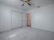 A bedroom features a closet and neutral carpeting at 32708 Westwood Loop, Leesburg, FL 34748