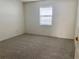 Bright bedroom with carpet flooring and a window for lots of natural light at 32708 Westwood Loop, Leesburg, FL 34748