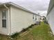 The exterior of this home has simple landscaping and vinyl siding at 32708 Westwood Loop, Leesburg, FL 34748