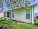Home exterior showcasing the well-maintained lawn and screened in porch for outdoor enjoyment at 32708 Westwood Loop, Leesburg, FL 34748