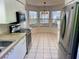 The kitchen features white cabinets, stainless steel appliances and a bright, sunlit breakfast nook at 32708 Westwood Loop, Leesburg, FL 34748