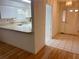 A partial view of the kitchen with white cabinets and a beige countertop at 32708 Westwood Loop, Leesburg, FL 34748