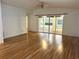 Bright living room with ceiling fan, wood flooring and sliding doors to an enclosed porch at 32708 Westwood Loop, Leesburg, FL 34748