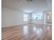 Spacious living room boasts wood floors, large windows, and an open layout to the nearby kitchen at 32708 Westwood Loop, Leesburg, FL 34748