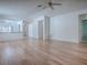 Large living room provides wood floors, an open design, and access to the hallway and kitchen at 32708 Westwood Loop, Leesburg, FL 34748