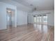 Bright living room features sleek wood floors, and sliding glass doors to screened patio at 32708 Westwood Loop, Leesburg, FL 34748
