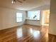 Open living area with laminate floors, a ceiling fan, and a view into the kitchen at 32708 Westwood Loop, Leesburg, FL 34748