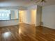 Living room with view of kitchen, hallway and laminate wood flooring at 32708 Westwood Loop, Leesburg, FL 34748