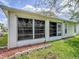 The back of the house showing the large screened in porch at 32708 Westwood Loop, Leesburg, FL 34748