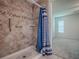 A tiled walk-in shower with grab bars is next to the bedroom at 32708 Westwood Loop, Leesburg, FL 34748