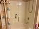 Bathtub with a seashell-themed shower curtain and grab bar at 32708 Westwood Loop, Leesburg, FL 34748