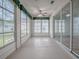 Enclosed sunroom with large windows, ceiling fan, and access to the backyard at 32708 Westwood Loop, Leesburg, FL 34748