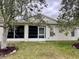 A sunroom and door are visible at the rear of this home's exterior at 32708 Westwood Loop, Leesburg, FL 34748