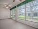 A view of the enclosed sunroom features large windows overlooking the green yard at 32708 Westwood Loop, Leesburg, FL 34748