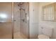 Clean bathroom featuring a shower with grab bars, toilet, and storage at 354 Hawthorne Blvd, Leesburg, FL 34748