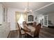 Elegant dining room with chandelier, hardwood table, and natural light at 354 Hawthorne Blvd, Leesburg, FL 34748