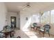 Bright sunroom with tile flooring, ceiling fan, and large windows offering natural light at 354 Hawthorne Blvd, Leesburg, FL 34748