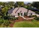 Aerial view shows beautiful home with lush landscaping, manicured lawn, and inviting entrance at 39136 Harbor Hills Blvd, Lady Lake, FL 32159