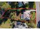 Aerial view showcases property, pool, and lush landscaping with privacy and space at 39136 Harbor Hills Blvd, Lady Lake, FL 32159