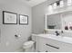 Modern bathroom with white vanity, framed art, and updated fixtures at 39136 Harbor Hills Blvd, Lady Lake, FL 32159