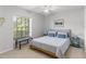 Well-lit bedroom with a ceiling fan, and a large window overlooking greenery at 39136 Harbor Hills Blvd, Lady Lake, FL 32159