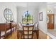 Formal dining room features wood floors, a mirror, chandelier, and a wooden dining table at 39136 Harbor Hills Blvd, Lady Lake, FL 32159