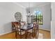 Formal dining room with natural light, featuring a dining table and an elegant chandelier at 39136 Harbor Hills Blvd, Lady Lake, FL 32159