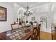 Elegant dining room with a chandelier, dining table, and access to other living spaces at 39136 Harbor Hills Blvd, Lady Lake, FL 32159