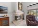 Close-up view of the fireplace featuring tan colored tile, flanked by furniture and decoration at 39136 Harbor Hills Blvd, Lady Lake, FL 32159