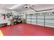 Spacious garage with red floors and golf cart at 39136 Harbor Hills Blvd, Lady Lake, FL 32159