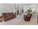 Expansive living room featuring tall ceilings and a large window, with comfortable leather furniture at 39136 Harbor Hills Blvd, Lady Lake, FL 32159