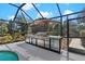 Well-equipped outdoor kitchen featuring a large grill, ample counter space, and a shaded dining area by the pool at 39136 Harbor Hills Blvd, Lady Lake, FL 32159