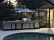 Modern outdoor kitchen with a grill, storage, and counter space adjacent to the pool, perfect for outdoor entertaining at 39136 Harbor Hills Blvd, Lady Lake, FL 32159