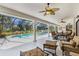 Spacious covered patio with ceiling fans overlooking a screened-in pool area at 39136 Harbor Hills Blvd, Lady Lake, FL 32159