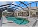 Inviting screened pool area with an outdoor kitchen, comfortable seating, and a relaxing ambiance for entertaining at 39136 Harbor Hills Blvd, Lady Lake, FL 32159