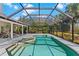 Inviting screened-in pool and spa with lush tropical foliage at 39136 Harbor Hills Blvd, Lady Lake, FL 32159