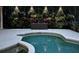 Inviting in-ground pool with lush landscaping and decorative lighting creating a backyard oasis at 39136 Harbor Hills Blvd, Lady Lake, FL 32159