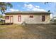 Backyard view of home showing door, windows, and exterior siding at 401 S 6Th St, Leesburg, FL 34748