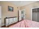 A bedroom featuring a view of the closet and hardwood floors at 401 S 6Th St, Leesburg, FL 34748