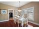 Cozy dining area with hardwood floors, natural light, and a view to the kitchen through the doorway at 401 S 6Th St, Leesburg, FL 34748