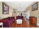 Well-lit living room boasting hardwood floors, neutral walls, ample seating, and an open view to the dining area at 401 S 6Th St, Leesburg, FL 34748