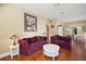 Cozy living room with hardwood floors, neutral paint, and ample seating with a view to the dining room at 401 S 6Th St, Leesburg, FL 34748