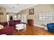 Bright living room with hardwood floors, neutral walls, and a view to the dining room through the open doorway at 401 S 6Th St, Leesburg, FL 34748