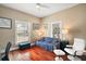 Sitting room with windows providing natural light and a comfortable blue sofa at 401 S 6Th St, Leesburg, FL 34748